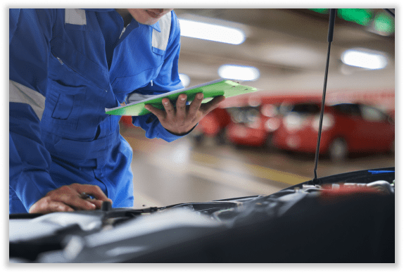 Inspector with tablet checking car